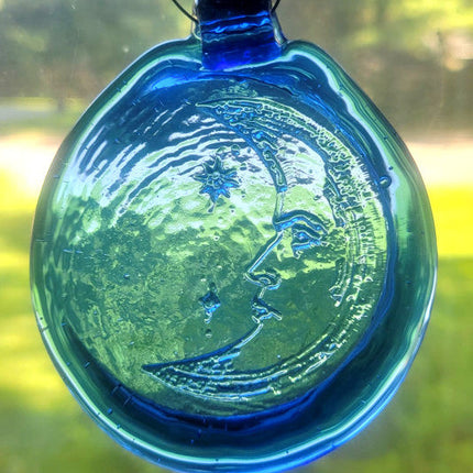 Blue glass suncatcher with a crescent moon design.