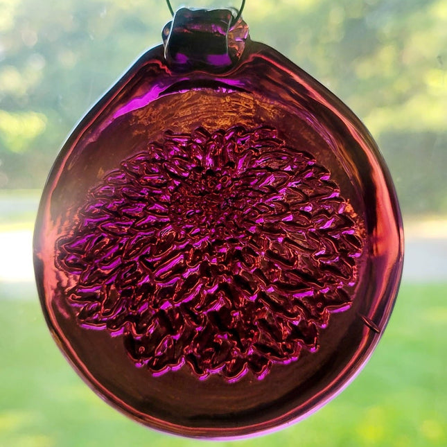 Dark purple glass suncatcher with a chrysanthemum flower design.