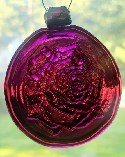 Purple glass suncatcher with a rose design.