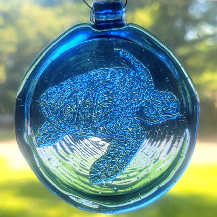 Blue suncatcher with a sea turtle design.
