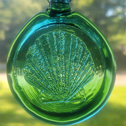 Teal green suncatcher with a scallop shell design.