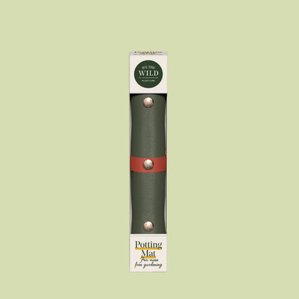 the tabletop potting mat rolled up in its package showing the olive green potting mat against a pale green background