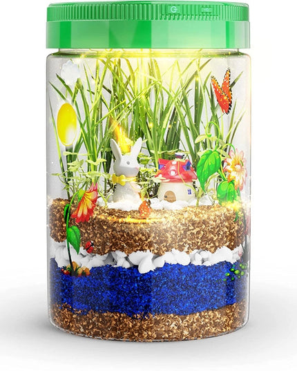 kids light up terrarium showing growing plants, decorative figures and stickers, and layers of soil